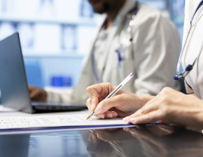 Physician writing a prescription treatment plan to help with recovery, recommending a suitable healthcare strategy based on radiography results and hospital records. Medicare meeting. Close up.